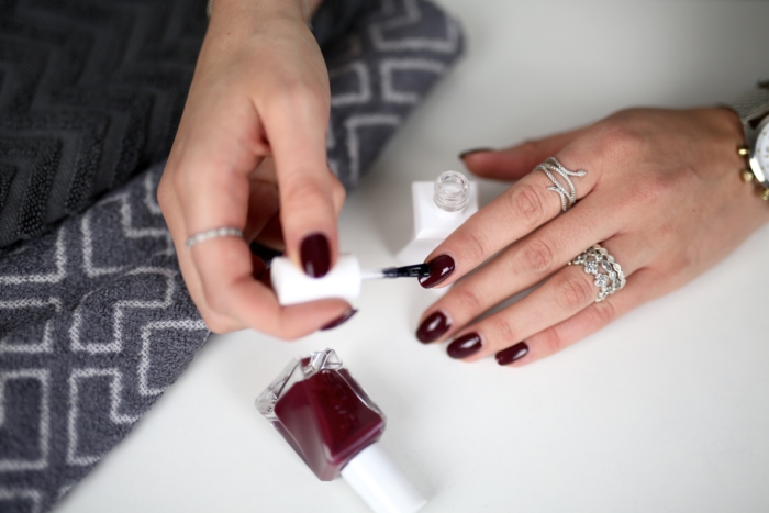 painting fingernails, dark red nail polish