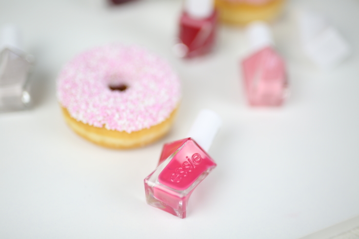 pink nailpolish, donut with pink sprinkles