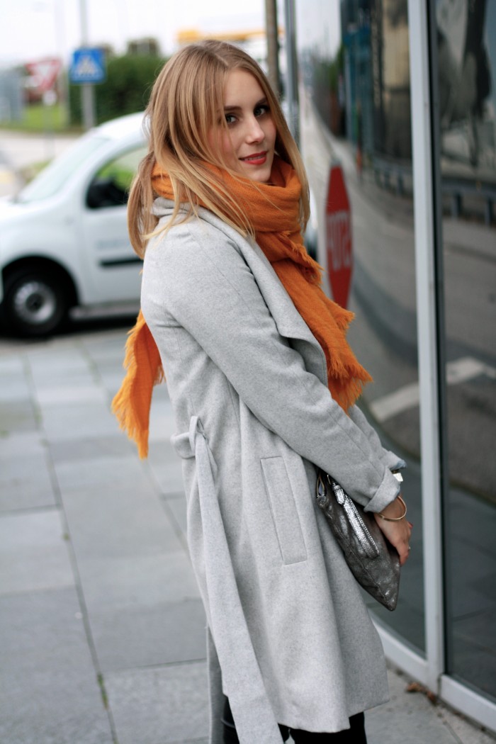grey coat and orange scarf
