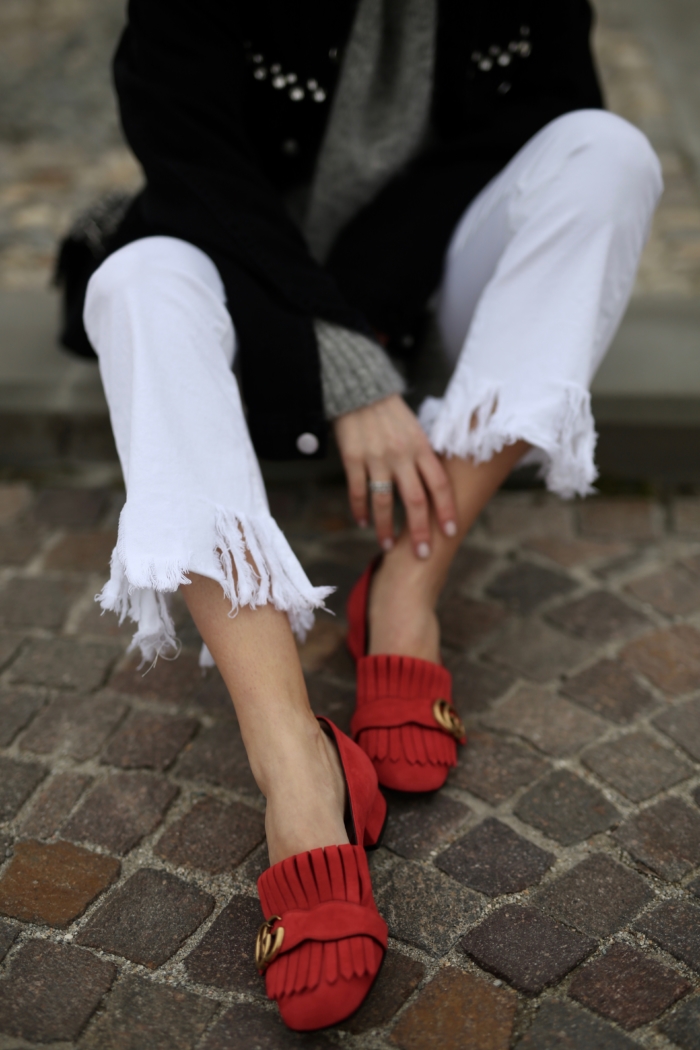 white jeans with fringes, red Gucci loafers