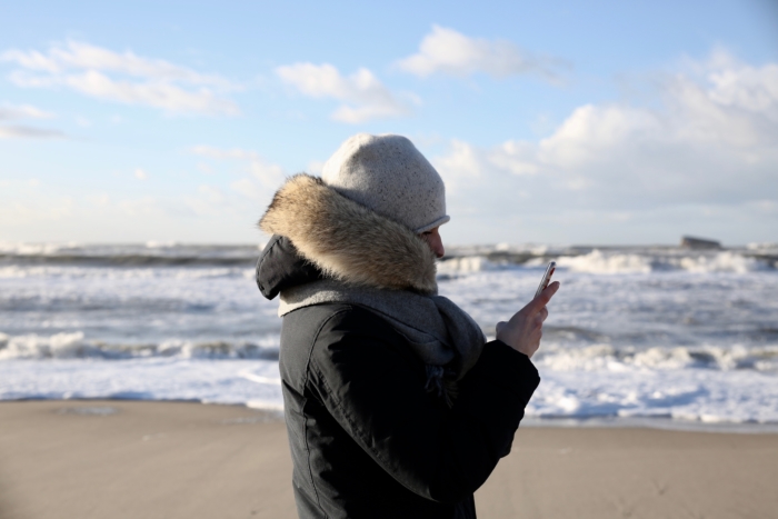 winter jacket, hat cos, cellphone