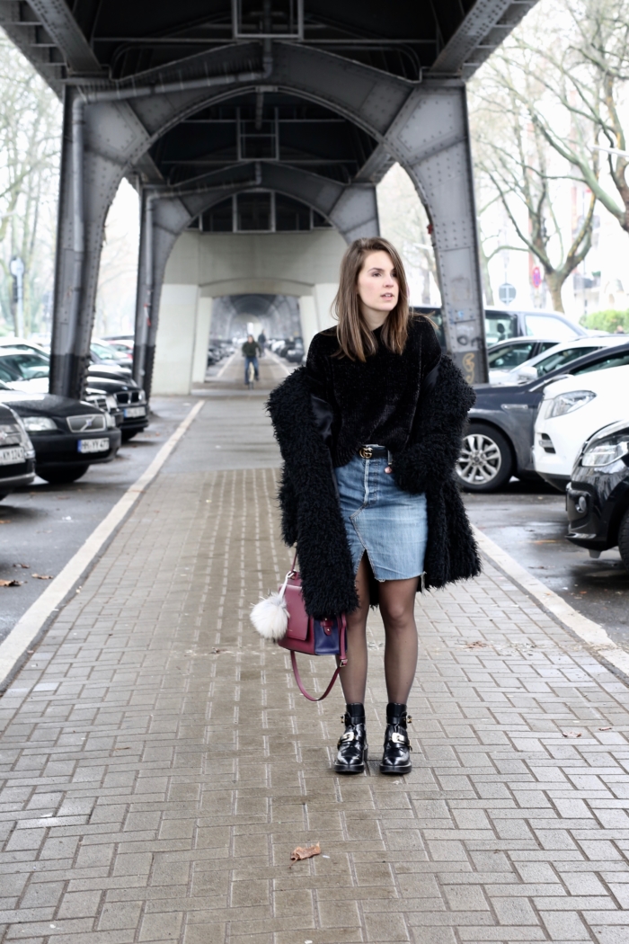 jeans skirt, black teddy coat, black velvet sweater, red purse