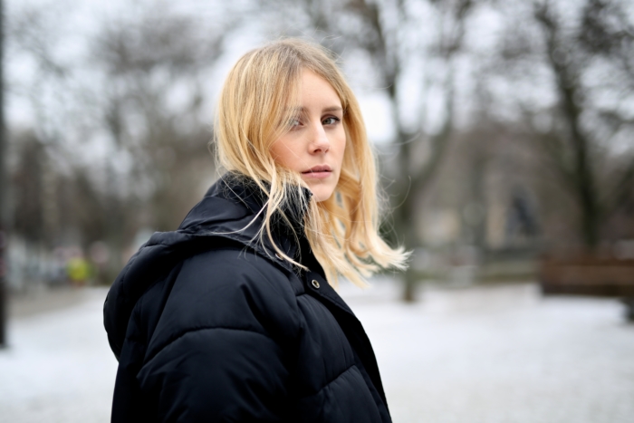 blonde, black winter jacket