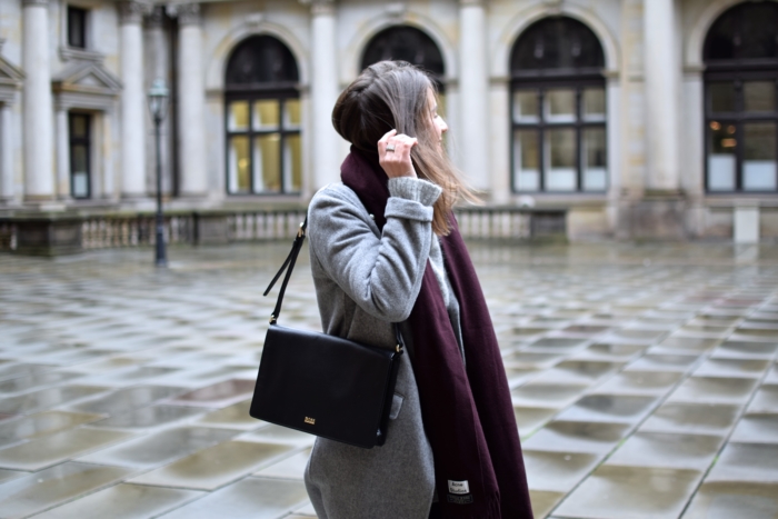 grey coat, black bag, red scarf