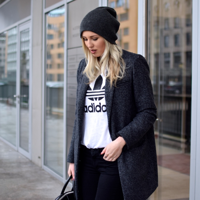 dark grey wool coat, white adidas shirt, black hat