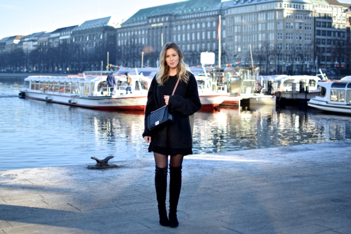 black oversized sweater, chanel handbag, overknee boots