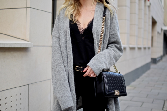 grey knitted cardigan, black top with lace, black and gold chanel bag, details