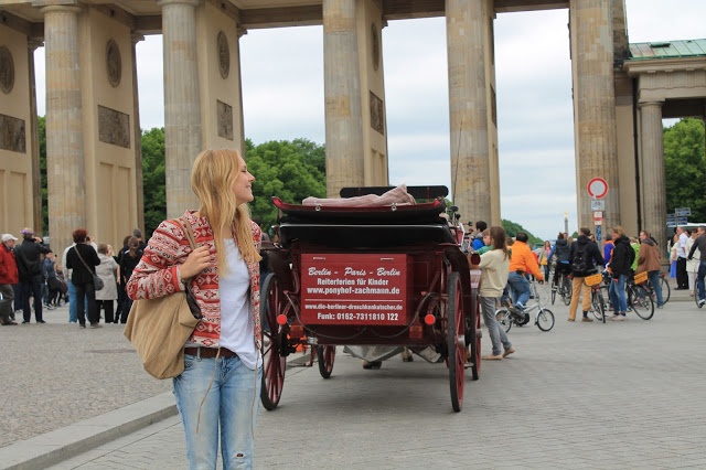 Blondes Model mit rot gemusterter Jacke vor dem Brandenburger Tor