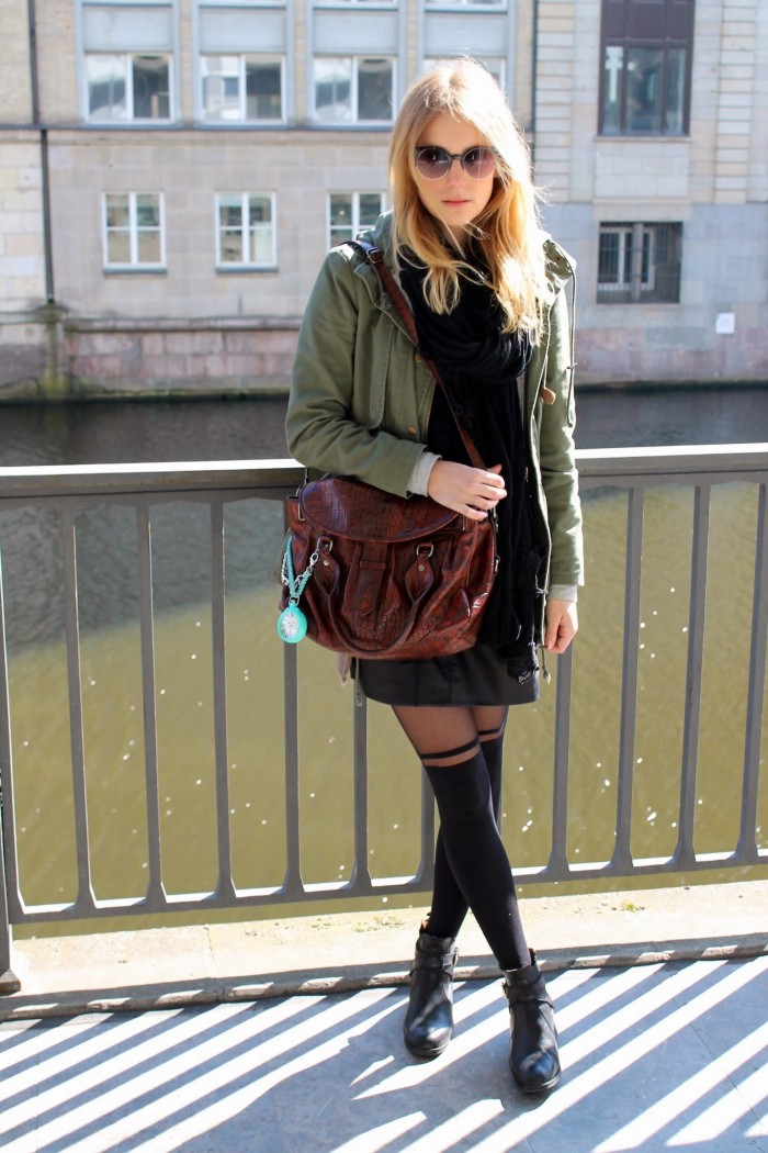 Model wearing brown bag with turquoise pocket watch