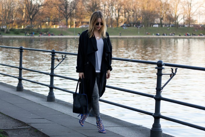 Girl wearing a long black trench coat