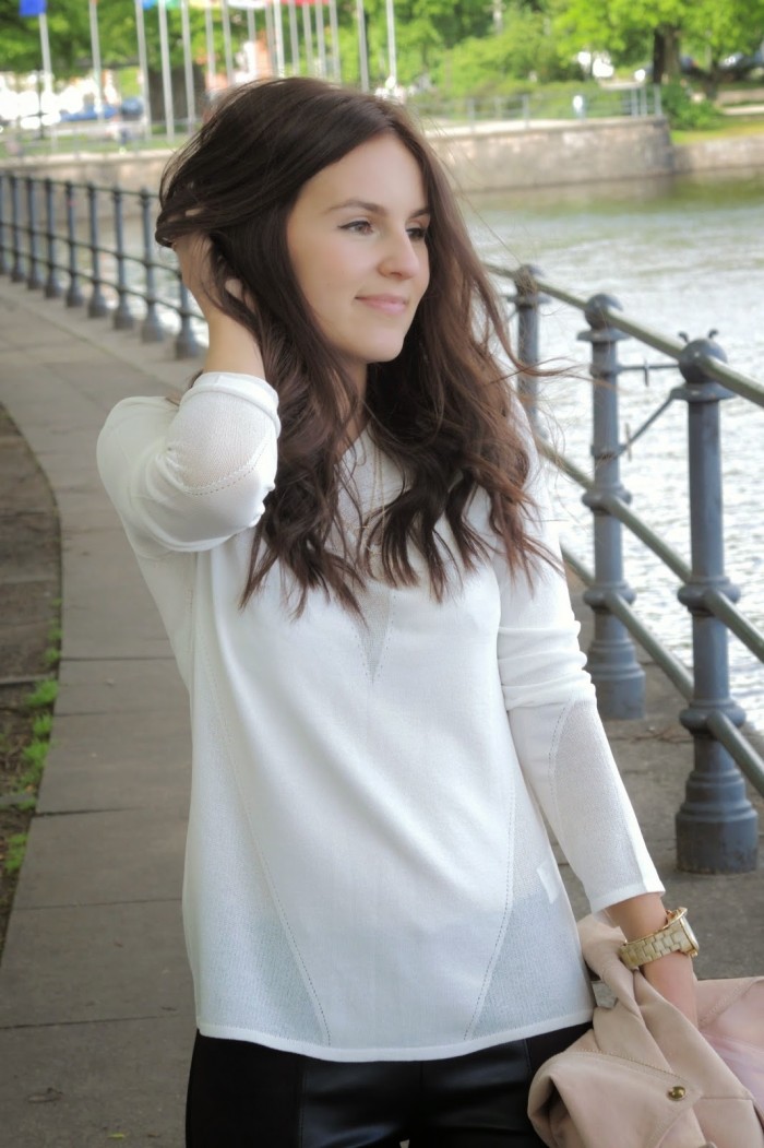 Brünettes Model trägt einen weißen Pullover von Hugo Boss