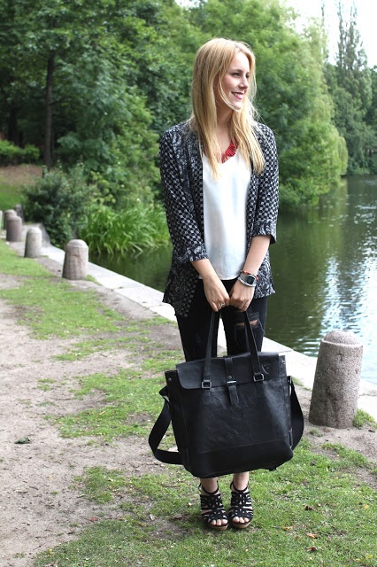 White top with black pants and black bag