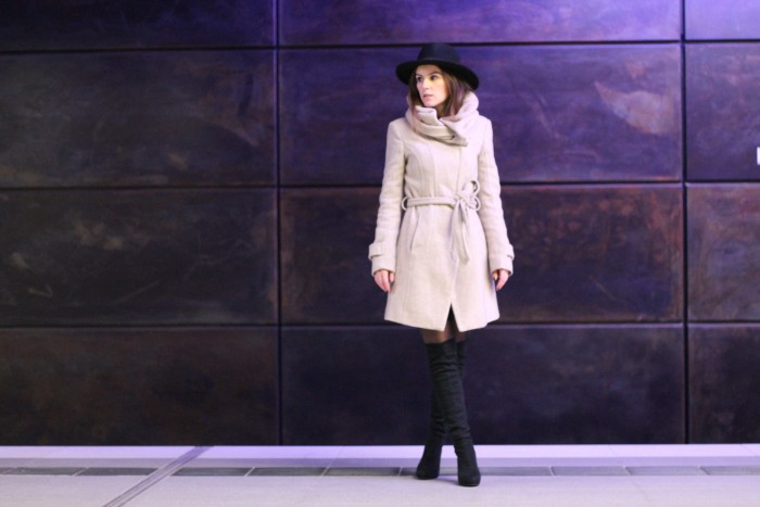 beige coat and black overknees